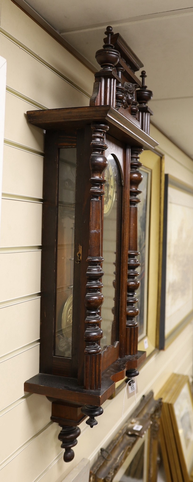 A 19th century German architectural beech and walnut wall clock, 100 cms high